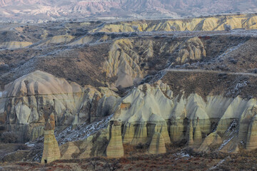 Wall Mural - Fairy tale chimneys in Cappadocia with blue sky on background in Goreme,Nevsehir, Turkey. Volcanic rock landscape, Stone houses. 