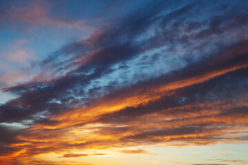 Wall Mural - Gorgeous panorama scenic of the strong sunrise with clouds on the orange sky.