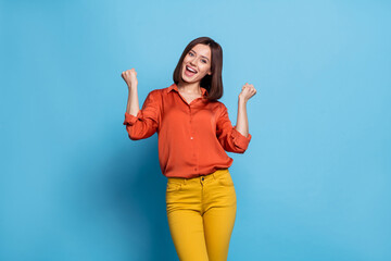 Wall Mural - photo of young cheerful excited girl rejoice success fist hands awesome isolated over blue color bac