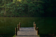 A Tranquil Scene Of The Wooden Bridge Juts Into The Reservoir At Pang Oung, Mae Hong Son, Thailand.