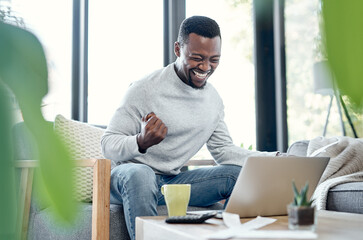 Poster - Debt free is the life for me. Shot of a young man celebrating while going over paperwork and using a laptop at home.