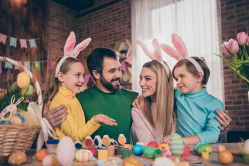 Poster - Portrait of attractive funny cheerful family wife husband coloring eggs creative art hugging cuddling pastime indoors