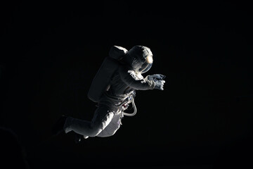 caucasian female astronaut using her mobile phone during spacewalk, messaging, taking pictures