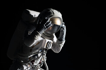 Wall Mural - full portrait of caucasian female astronaut during spacewalk, black deep space background