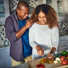 Poster - I cant wait to taste it. Cropped shot of an attractive young woman cooking at home while her husband keeps her company.