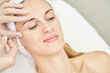 © elenavolf - Injection at spa salon. Doctor hands in gloves. Closeup. Pretty female patient. Beauty treatment. Healthy skin procedure. Young women face. Plasmolifting rejuvenation