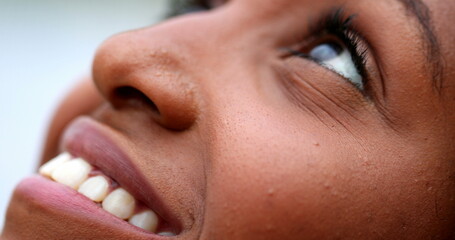 Hopeful African black woman looking up to sky with Hope and peace