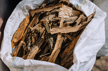 The peeled bark of an acacia tree, spruce lies in a bag close-up.