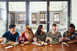 © Connect Images - Smiling friends enjoying meal in restaurant