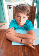 Portrait Of Boy Doing Homework At Table