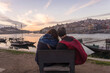 © Connect Images - Portugal, Porto, Rear view of couple facing Douro river at sunset
