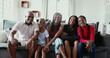 © Marco - Family posing for photo at home couch, black African ethnicity parents and children smiling at camera