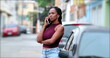 © Marco - Candid African woman speaking on phone outside. Casual black woman talking on cellphone in street