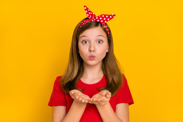 Poster - Portrait of adorable kind teenager little girl send you appreciation kiss wear isolated on yellow color background