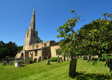 St Margarets Church At Hemmingford Abbots Cambridgeshire England Blue Sky And Grave Stones.