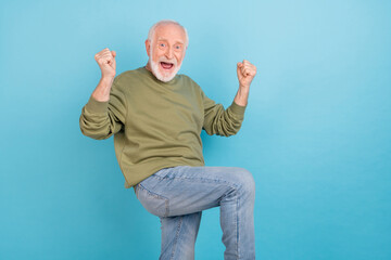 Sticker - Portrait of attractive cheerful grey-haired man rejoicing having fun attainment isolated over shine blue color background