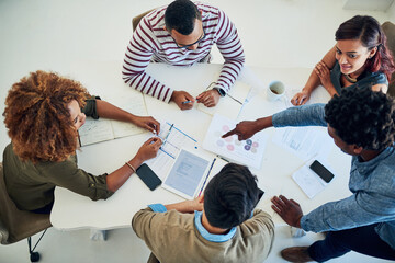 Poster - Sharing the workload is a sure way to success. Shot of a group of colleagues having a meeting in a modern office.
