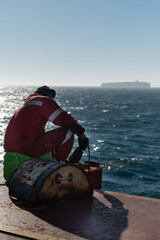 Wall Mural - Seaman ship crew working on deck cutting with flex machine grinder after carriage of cargo.