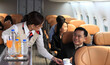 © sittinan - Cabin crew pushing service cart and serve to customer on the airplane during flight. hostess service on plane
