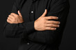 © Pixel-Shot - Man with stylish manicure and crossed hands on black background, closeup
