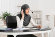 © Pixel-Shot - Muslim secretary working in office