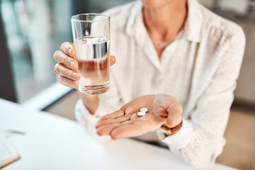 Poster - Vitamins are vital for our immune systems. Closeup shot of an unrecognisable businesswoman holding a glass of water and medication in an office.