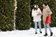 © Pixel-Shot - Loving couple with shopping bags walking on snowy winter day
