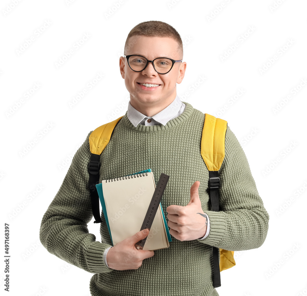 Male student with notebooks and ruler showing thumb-up on white background