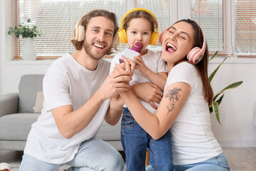 Sticker - Happy family with headphones and microphone singing song at home