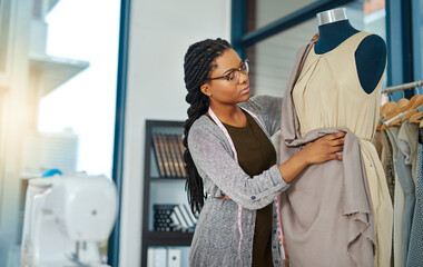 Sticker - Believe in yourself and be prepared to work hard. Shot of a young woman working in her clothing boutique.