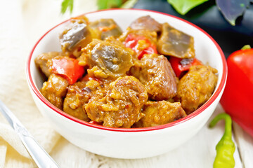 Wall Mural - Meat with eggplant and pepper in bowl on board