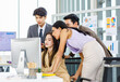 © Bangkok Click Studio - Asian male female professional businessman businesswoman colleagues in formal business suit helping teaching job task to new recruitment employee staff online via computer in company office workplace