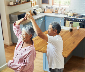 Sticker - Getting in a bit of morning dancing. Shot of a cheerful elderly couple dancing in the kitchen together at home during the day.