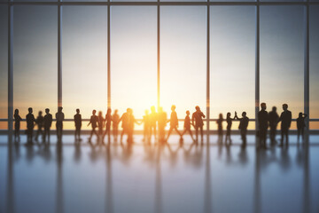 Backlit crowd of businessmen and women working together in bright office interior with sunlight. Teamwork and corporate workplace concept. Double exposure.