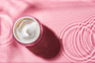 Poster - beauty cream on pink clear water