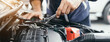 © A Stockphoto - Automobile mechanic repairman hands repairing a car engine automotive workshop with a wrench, car service and maintenance,Repair service.