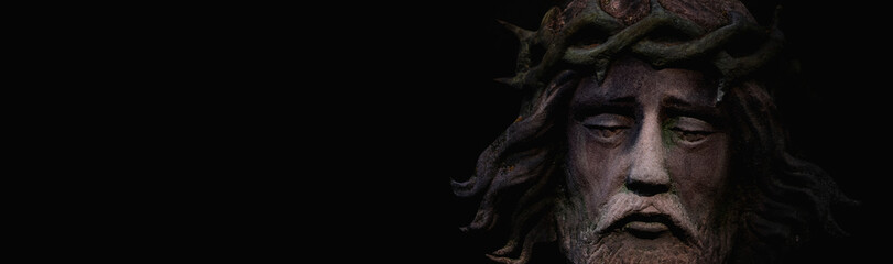 Fototapete - Dramatic image of  Jesus Christ in a crown of thorns. Fragment of an ancient statue. Copy space for text.