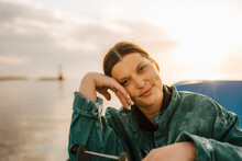 Portrait Of Smiling Woman At Sea At Sunset