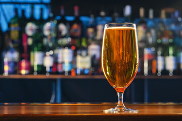 Wall Mural - Fresh cold beer in glass on bar background