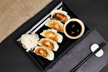 Poster - Top view of Japanese sushi rolls with soy sauce and sticks