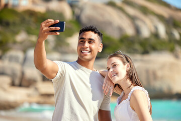 Poster - Take a selfie to capture this moment forever. Shot of a young couple taking selfies at the beach.