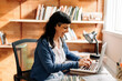 © (JLco) Julia Amaral - Smiling woman working in her home office