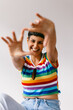 © (JLco) Julia Amaral - Smiling lesbian woman blocking the camera in a studio