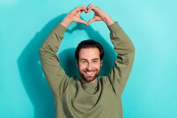 Sticker - Photo of optimistic beard young guy hands heart wear khaki sweatshirt isolated on teal color background