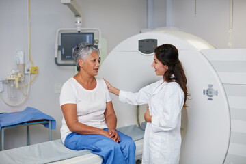 Poster - This is a totally noninvasive procedure. Shot of a senior woman being comforted by a doctor before and MRI scan.