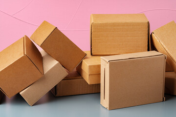 Set of cardboard boxes on pink background