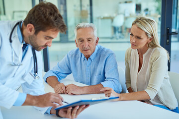 Poster - Lets take a closer look at your test results. Shot of a doctor discussing some paperwork with a senior patient and his daughter in a clinic.
