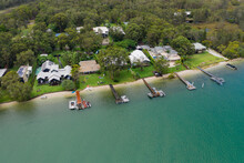 Aerial View Of Riverfront Properties With Private Jetties