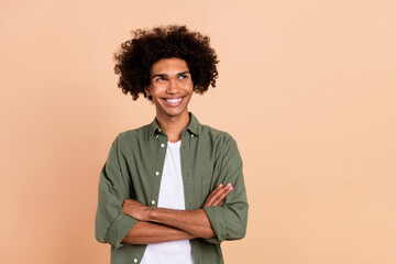 Poster - Portrait of attractive cheerful minded wavy-haired guy folded arms thinking copy space isolated over beige pastel color background