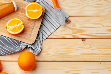 Wall Mural - Glass of fresh orange juice with fresh fruits on wooden table